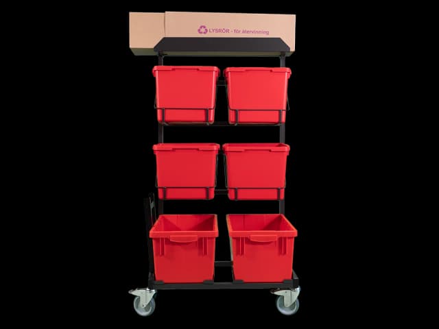 Tralle med røde plastbokser. Foto.